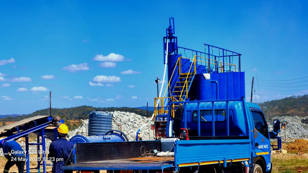 Truck-mounted mobile gold processing plant with conveyor, mill and tanks on a Zimbabwean mine site